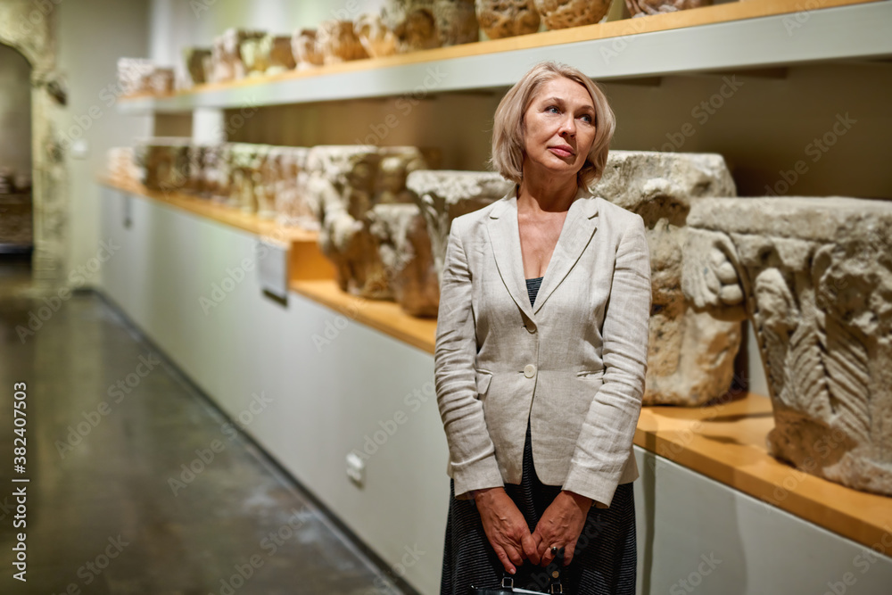 Woman exploring medieval expositions in museum