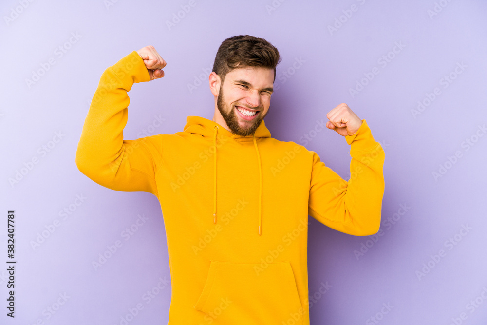 Young man isolated on purple background cheering carefree and excited. Victory concept. Young man isolated on purple background cheering carefree and excited. Victory concept.