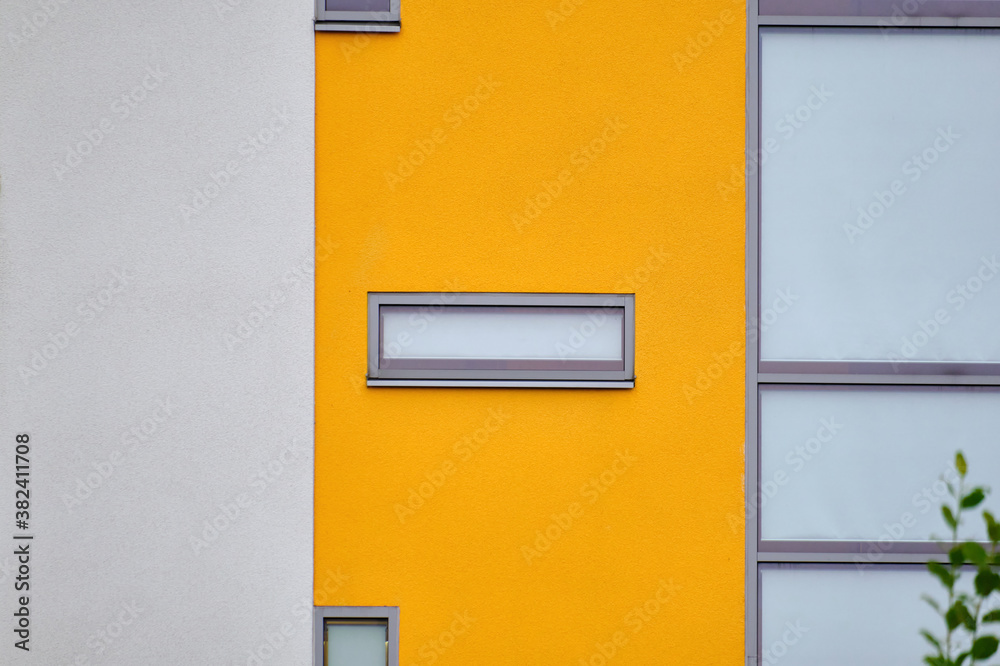 The modern yellow and white facade of the apartment building in Finland. The modern nordic architecture.