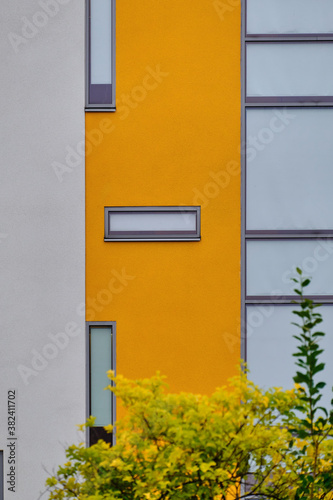 Obraz na płótnie The modern yellow and white facade of the apartment building in Finland. The modern nordic architecture. w salonie