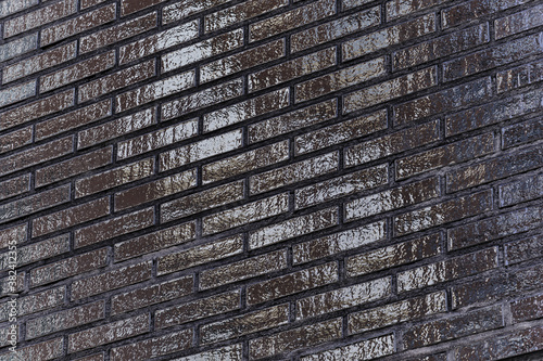Obraz na płótnie The black glossy brick wall of a modern apartment building. Modern nordic architecture. Pattern of brick wall. w salonie