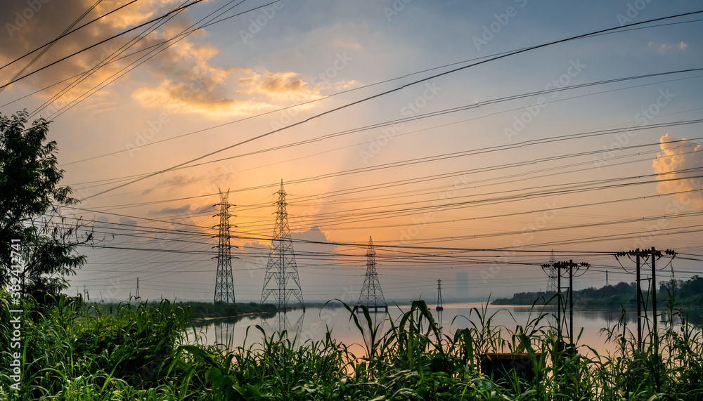 Obraz premium High-voltage power lines at Sunrise/sunset. .Saltpans in Mumbai.
