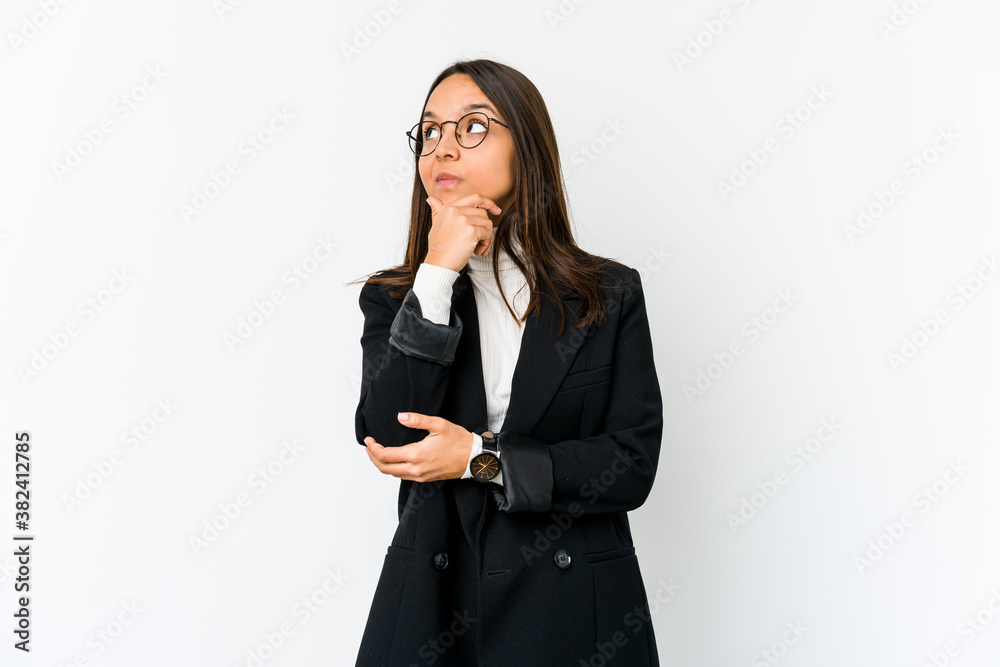 Young mixed race business woman isolated on white background thinking and looking up, being reflective, contemplating, having a fantasy. Young mixed race business woman isolated on white background thinking and looking up, being reflective, contemplating, having a fantasy.