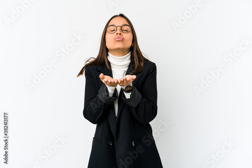 Young mixed race business woman isolated on white background folding lips and holding palms to send air kiss.