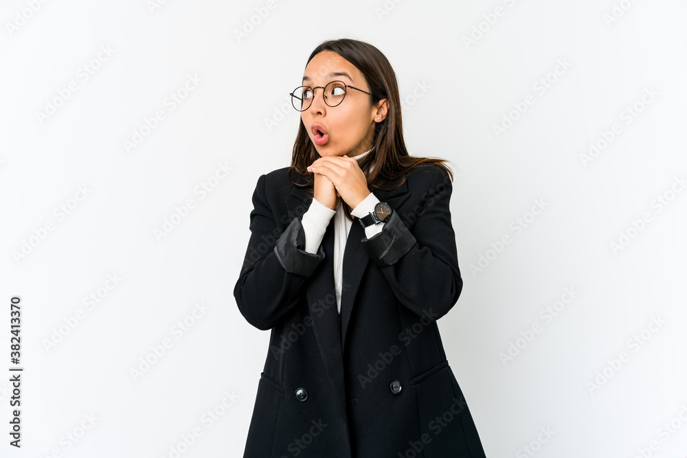 Young mixed race business woman isolated on white background praying for luck, amazed and opening mouth looking to front. Young mixed race business woman isolated on white background praying for luck, amazed and opening mouth looking to front.