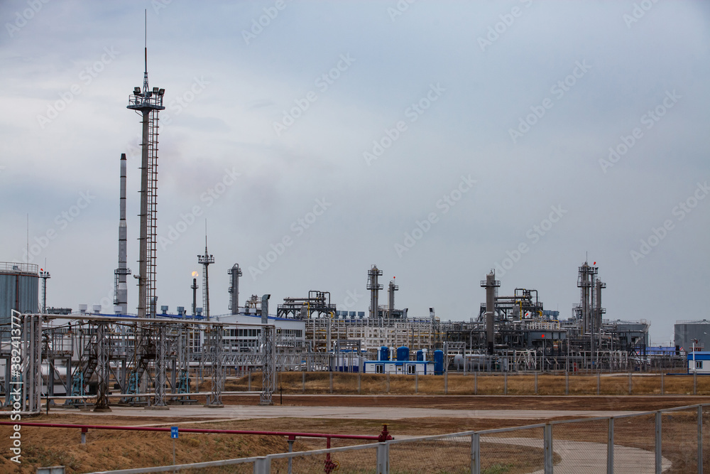 Oil refinery and gas processing plant panorama view. Gas torch and refinery columns and lightning conductor mast. Oil refinery and gas processing plant panorama view. Gas torch and refinery columns and lightning conductor mast.