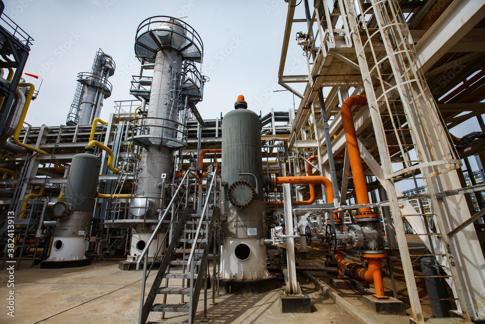 Oil refinery and gas processing plant. Distillation towers (refining column), pipelines, tubes, heat exchangers.