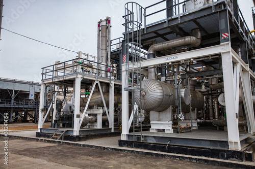 Grey metal equipment on oil refinery and gas processing plant. Heat exchanger and pipes.