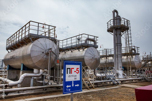 Oil refinery plant. Deaerator systems of boiler systems. Heat exchanger. Distillation column on grey sky background. Uralsk region, Kazakhstan
