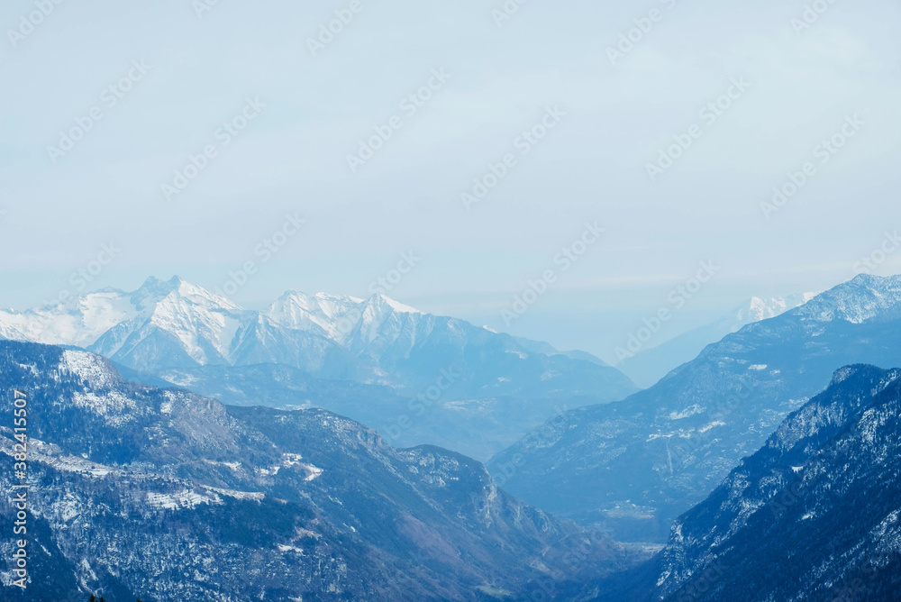 Fototapeta premium Winter landscape with mountain slopes covered with snow.