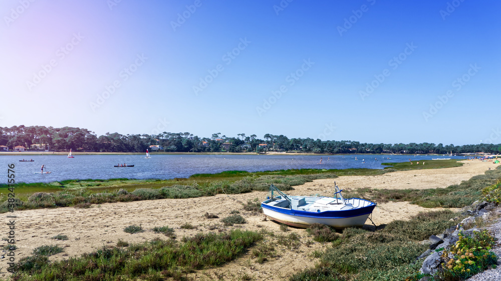 Boat stranded on the sand in front of Hossegor lake