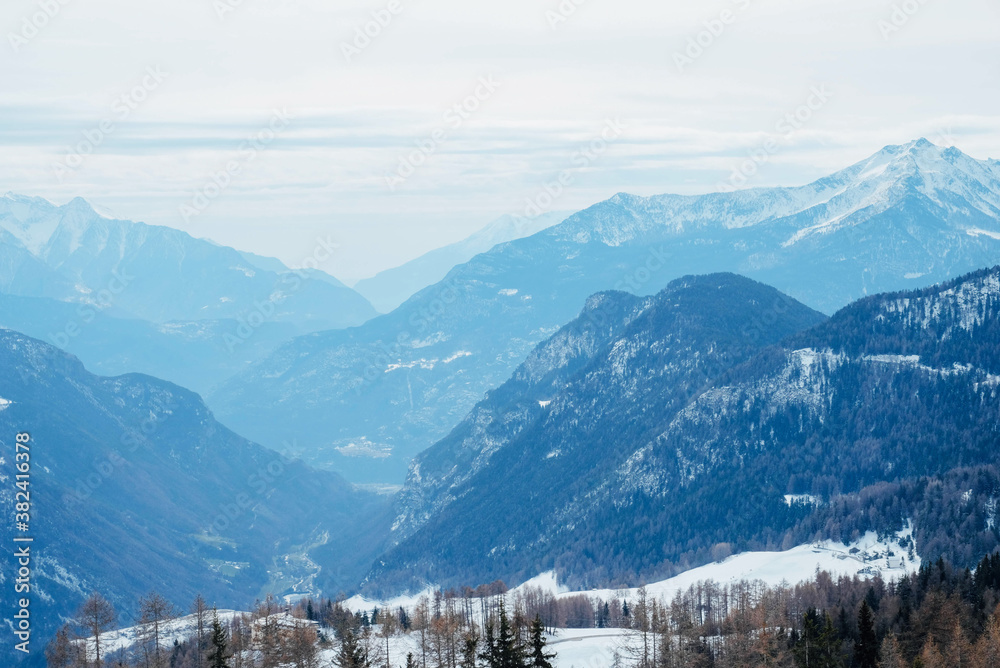 Winter landscape with mountain slopes covered with snow.
