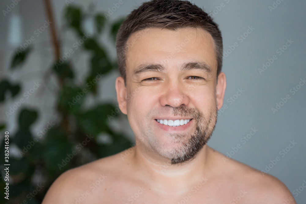 a man with stubble on one side of his face and shaved on the other. skin care concept. change of appearance. a man with stubble on one side of his face and shaved on the other. skin care concept. change of appearance.
