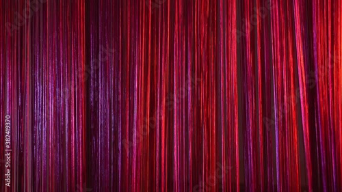 Young Contemporary dancer practising cabaret show behind a red courtain. Abstract movements and beautiful dance