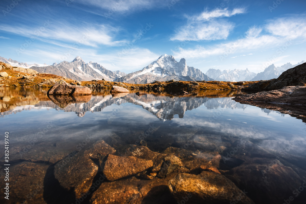 Naklejka premium Incredible view of clear water and sky reflection on Lac Blanc lake in France Alps. Monte Bianco mountains range on background. Landscape photography, Chamonix.