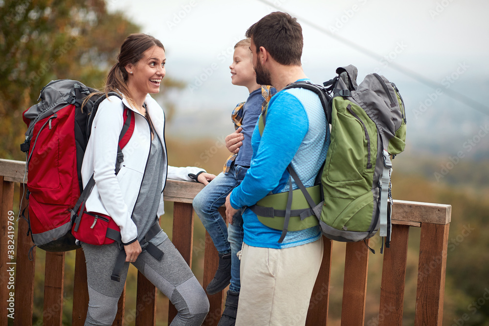 Obraz premium Happy couple with a son on a hiking; Active lifestyle concept