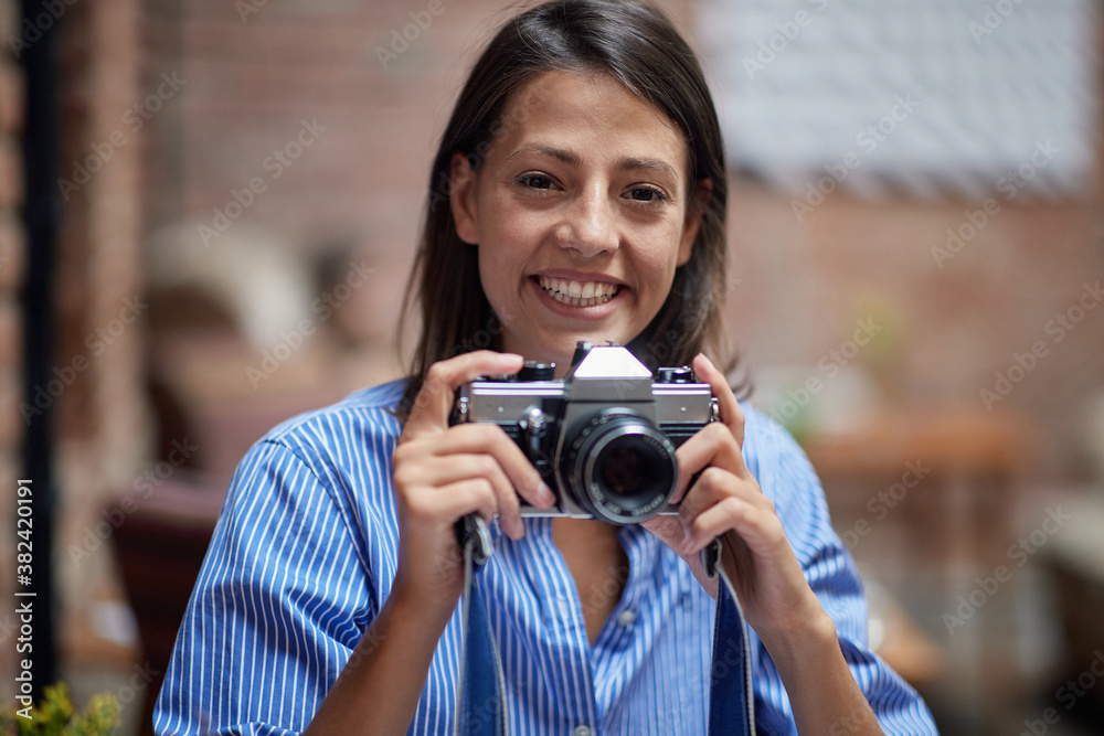 A beautiful girl with the camera posing for a photo A beautiful girl with the camera posing for a photo