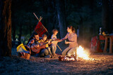 Family camping in the woods; Quality family time concept