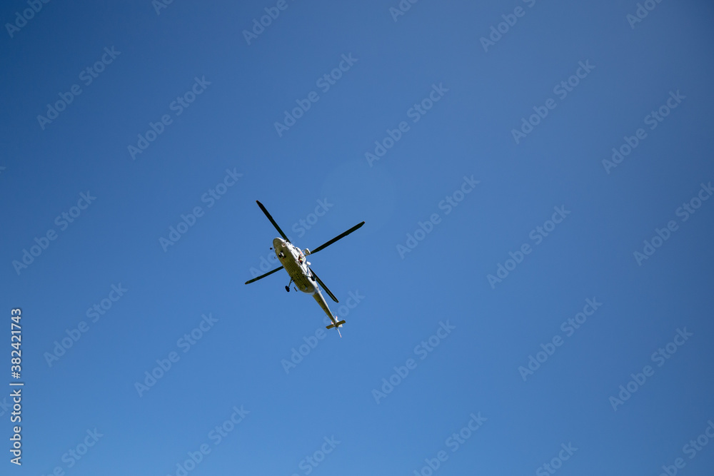 Helicopter flying in the blue sky. Themes rescue, help and hope. Helicopter flying in the blue sky. Themes rescue, help and hope.
