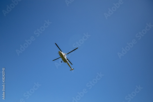 Helicopter flying in the blue sky. Themes rescue, help and hope.