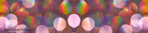 Shiny glitter celebration background. Blurred trendy rainbow multicolored bac...