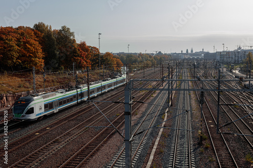 Helsinki, Uusimaa, Finland 2020 October 2, 2020 Railway tracks and a running train. Sunny, autumn day.