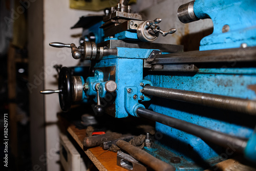 An old lathe in the garage under repair. Industrial equipment for factories. close-up 