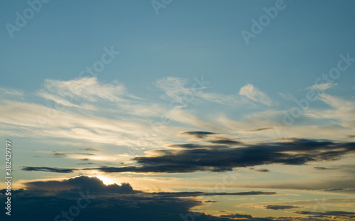 Sunset in the blue sky with white clouds © Denius