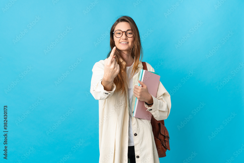Young Ireland student woman over isolated background doing coming gesture Young Ireland student woman over isolated background doing coming gesture