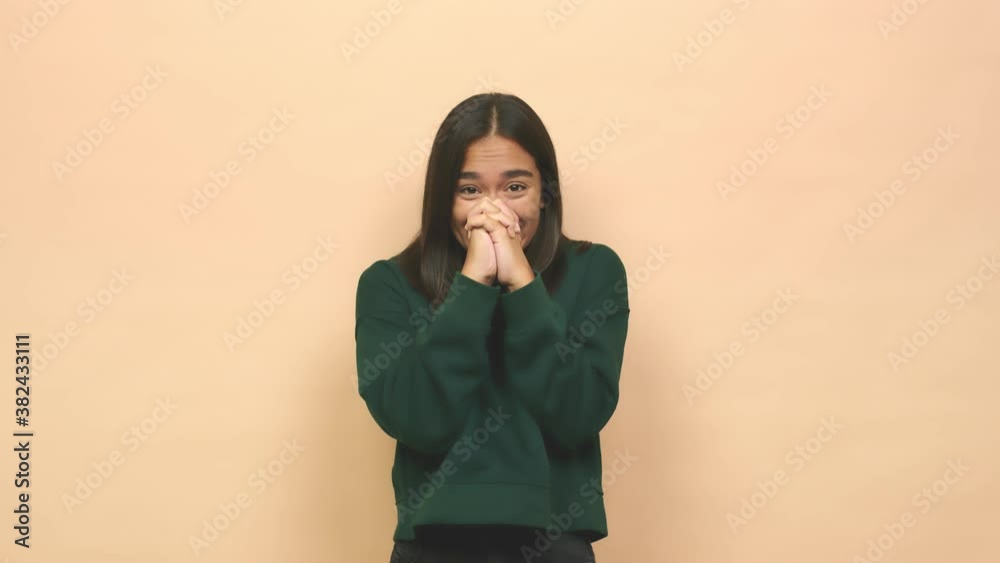 Young mixed race indian woman praying for luck, amazed and opening mouth looking to front Young mixed race indian woman praying for luck, amazed and opening mouth looking to front