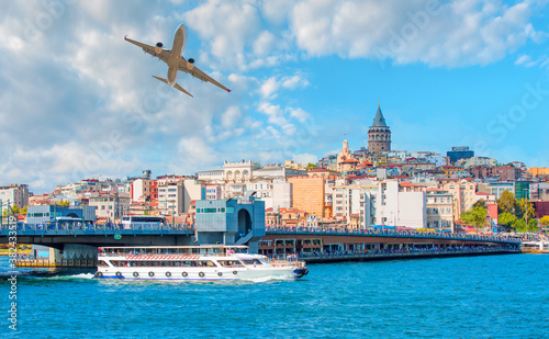 Airplane in the sky - Galata Tower, Galata Bridge, Karakoy district and Golden Horn with full moon at bright blue sky - Istanbul, Turkey