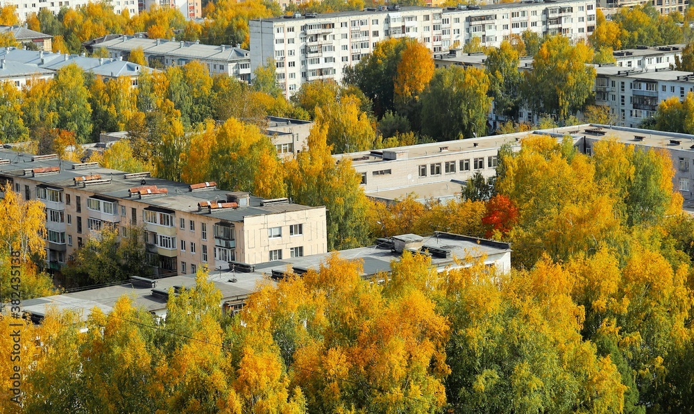 Soviet-style residential buildings among bright autumn trees