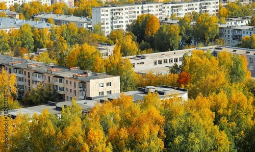 Soviet-style residential buildings among bright autumn trees