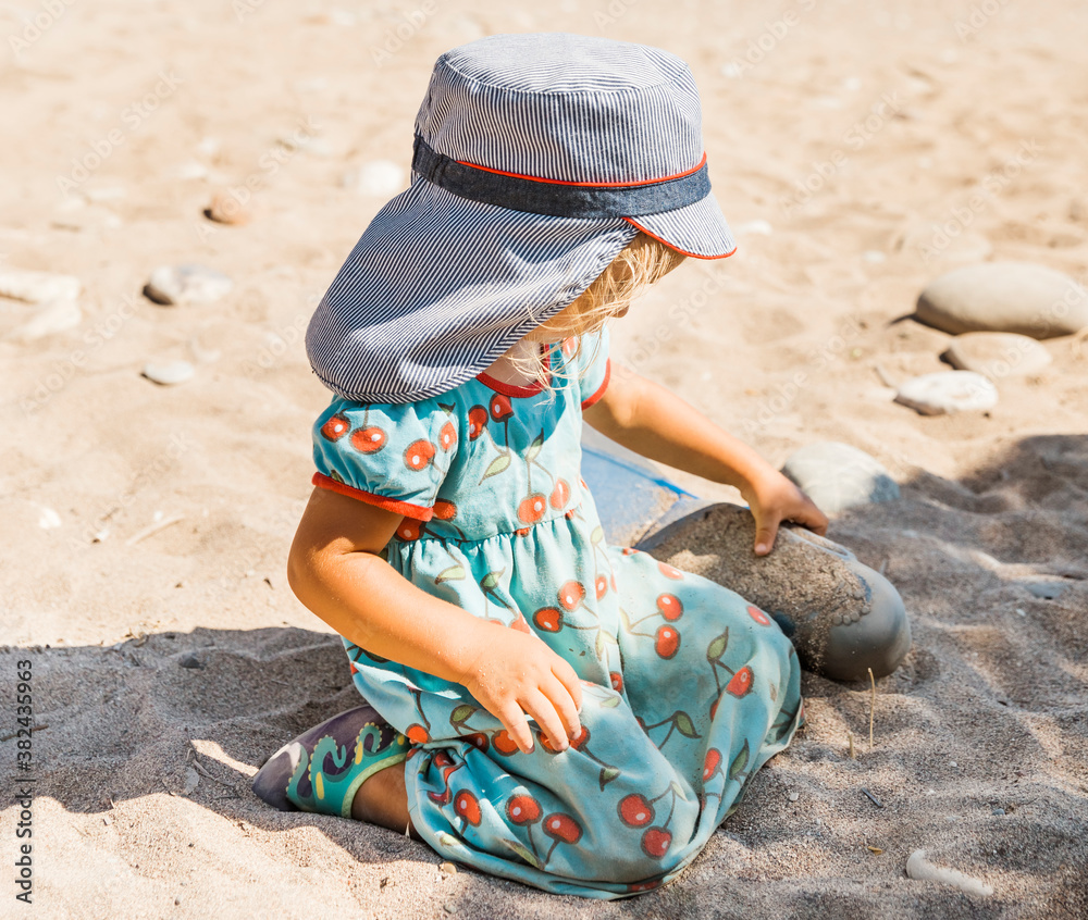 Toddler girl playing on beach