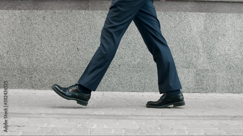 Business man legs walking in black shoes. Closeup black shoes walking outdoor © stockbusters