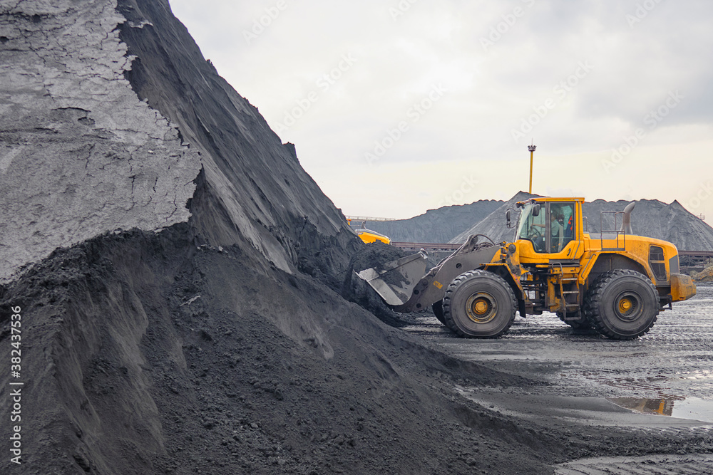 Wheel loader under operation at iron ore concentrate stockpile Wheel loader under operation at iron ore concentrate stockpile
