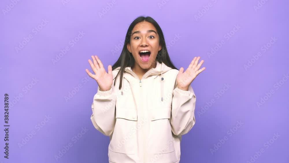 Young mixed race indian woman celebrating a victory or success, he is surprised and shocked Young mixed race indian woman celebrating a victory or success, he is surprised and shocked
