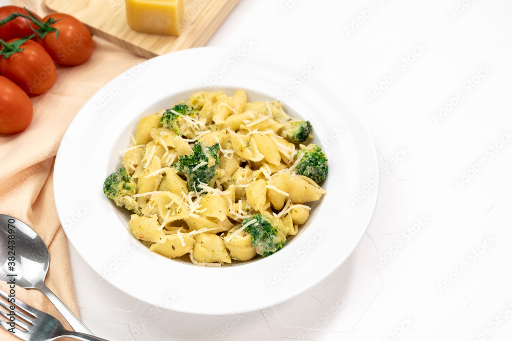 pastpasta with broccoli in creamy sauce in white plate