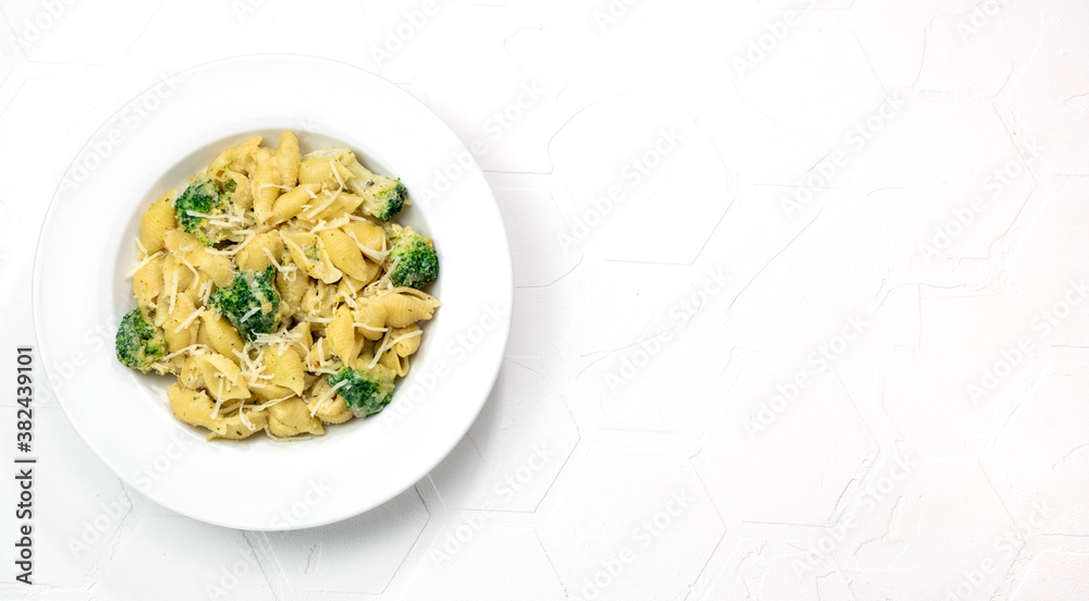 pasta with broccoli in creamy sauce in white plate pasta with broccoli in creamy sauce in white plate