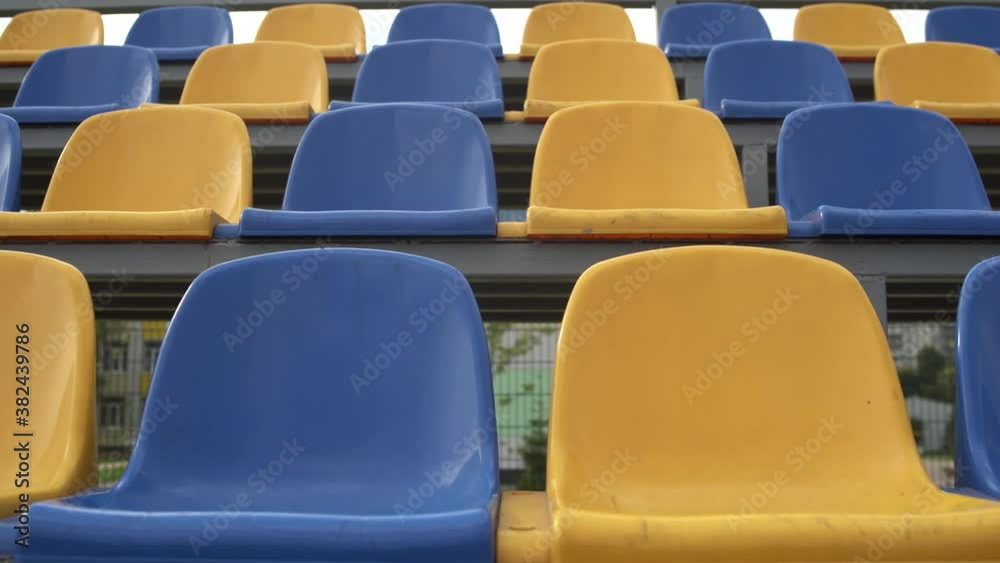 4K, Empty Rows and Seats of a Football Stadium. Plastic Seats At Stadium. Football During the Coronavirus Pandemic 4K, Empty Rows and Seats of a Football Stadium. Plastic Seats At Stadium. Football During the Coronavirus Pandemic