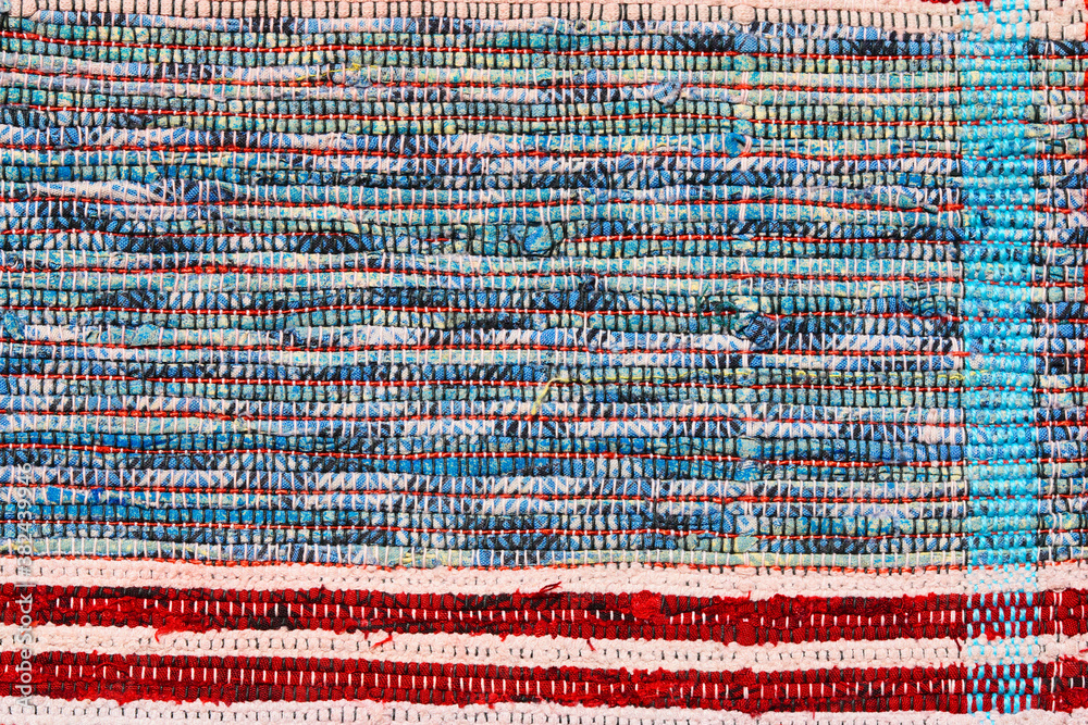 Multi Colored textile homespun rug. Folk nation creativity. Closeup.