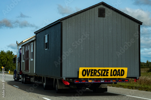 Sheds as oversize load on semi transport truck © Colin Temple
