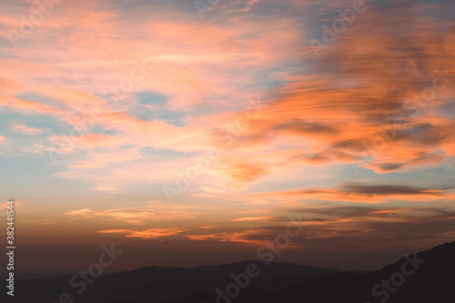 Fototapeta Naklejka Na Ścianę i Meble -  Sunset between mountains with clouds and colorful sky