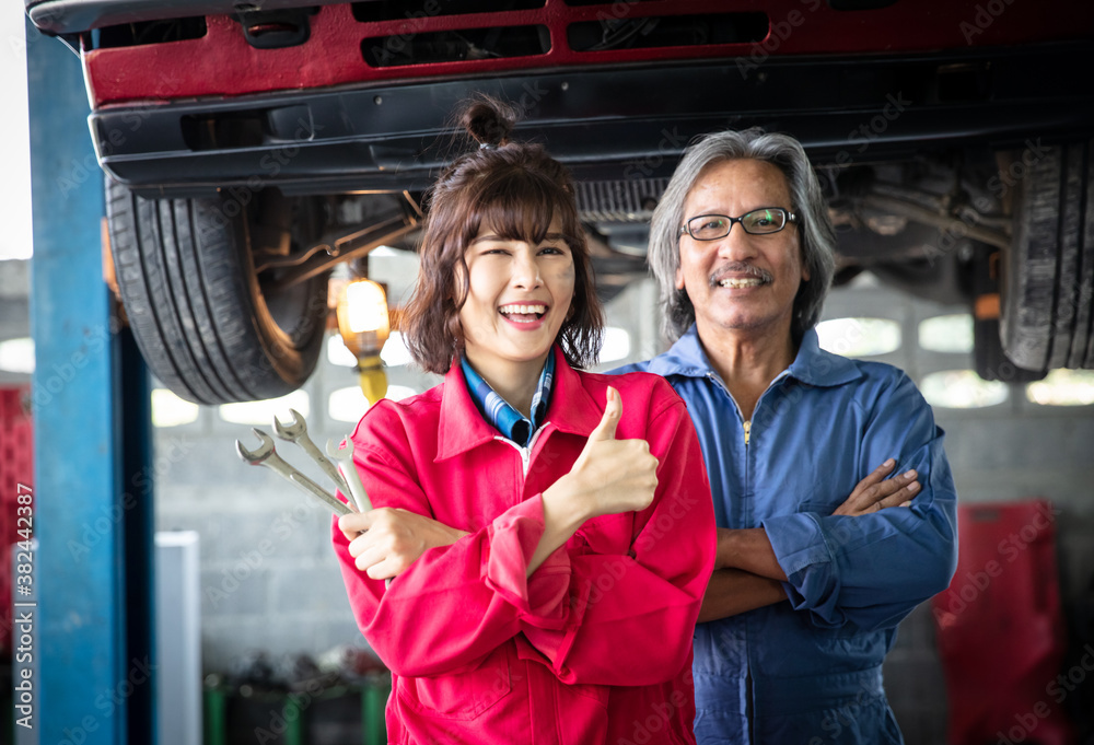 Portrait Female technician and her supervisor at front car in Garage 