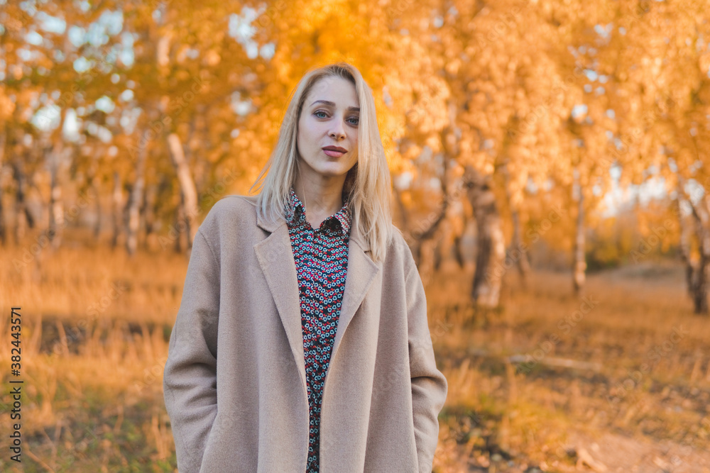 Young beautiful woman in long coat in autumn forest. Autumn concept. Young beautiful woman in long coat in autumn forest. Autumn concept.