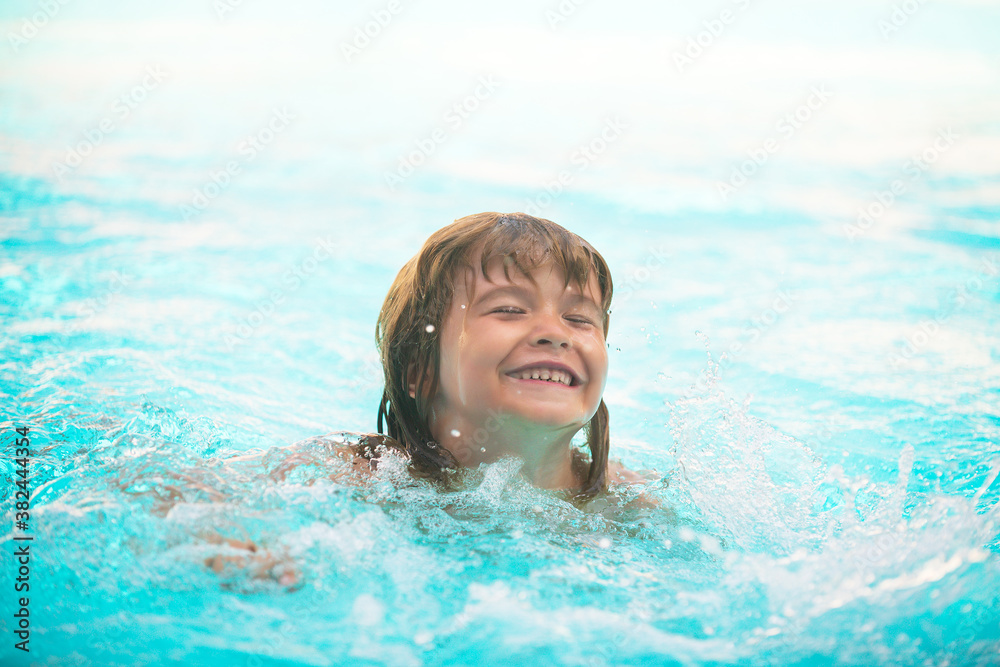 Happy kids boy swim in the sea. Funny little swimmer.