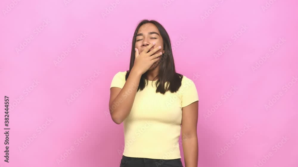 Young mixed race indian woman yawning showing a tired gesture covering mouth with hand Young mixed race indian woman yawning showing a tired gesture covering mouth with hand
