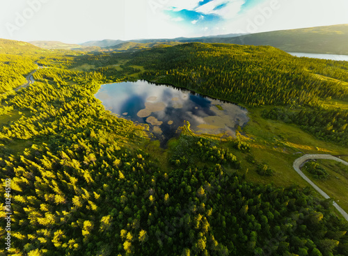 Bamselitjernet lake near Beitostolen surrounded by forests during sunset, Norway photo