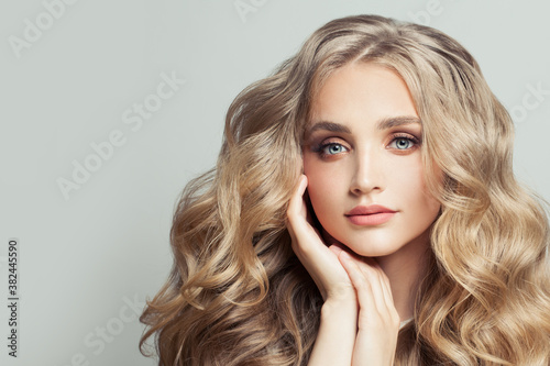 Perfect blonde woman with long healthy curly hair