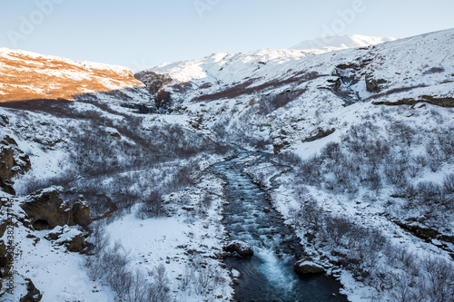 River streaming from the Glymur waterfall in winter  Iceland